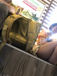 Cute Teen Delivery Girl in Shorts And Dirty Sneakers Sitting on a Windowsill Restaurant Creepshots Gallery