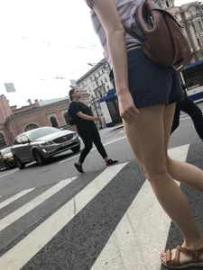 Young Girl in Shorts And Sandals Crossing the Street Gallery