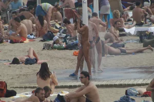 Topless girls on a beach in Barcelona