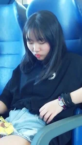 Two cute Asian teens on the bus in shorts showing their legs
