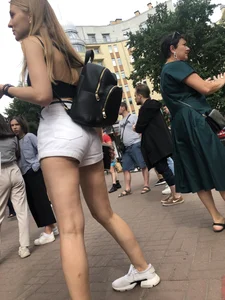 Hot Candid Girl in a Top, Shorts and Sneakers Skinny Legs Closeup Creepshots Gallery on the City Street