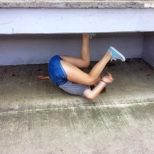 Skinny Teen in Blue Mini-Shorts Fooling Around on the Ground