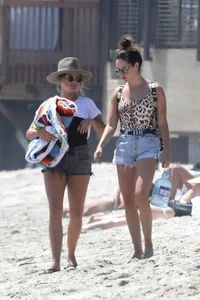 Ashley Tisdale in cheetah print swimsuit on the beach in Malibu