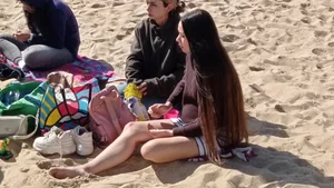 Beautiful Teen with Miniskirt resting on the beach