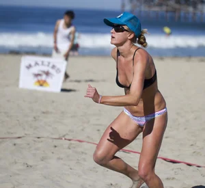Hot girls playing beach volleyball in bikinis and shorts