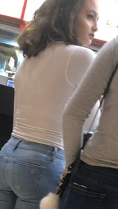 Girl in jeans in the mall food court