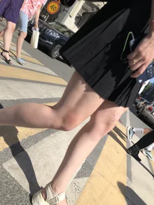 Legs of a hot candid girl on a crosswalk