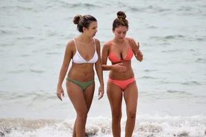 Two sexy ass girls on the beach in bikinis