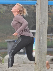 Beach volleyball blonde lady in tight leggings