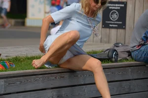 Blonde milf upskirted showing white panties and some pubes