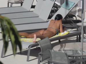 Hot milf sunbathing in a thong by pool and swimming