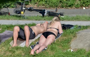 Thick blonde laying out in the sun in a bikini with her boyfriend