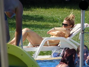 Topless lady at the pool with nice tits