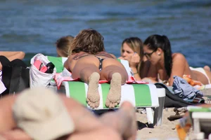 A couple sexy girls laying out on the beach