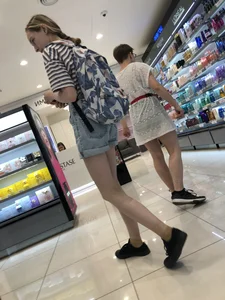 Girl in Blue Denim Shorts with Very Skinny Legs Store Candid