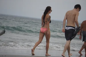 Peach bikini tattood babe on the beach with a nice ass and some camel toe