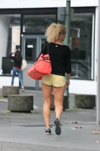 Blonde looking sexy walking in short yellow shorts