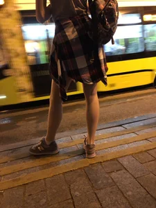 Cute Teen in Shorts on the Tram Stop
