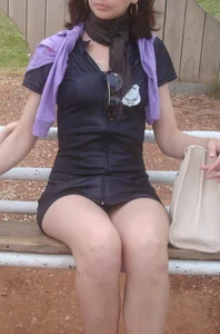 Sexy young milf in a short dress sitting on a bench, she's got hot legs