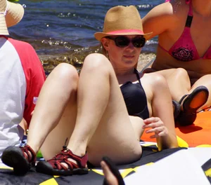Sexy party girls in bikinis on a lake