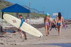 Candid girls surfing on the beach
