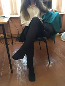 Young College Girl in Black Pantyhose, a Blouse And a Skirt in a Classroom Photos
