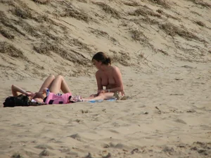 Topless beach girl with nice titties with her friend in a bikini