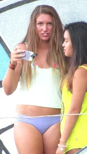 Two sexy girls taking pics in bikinis see the camera guy shooting them