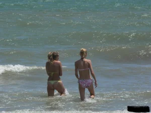 Sexy blonde on the beach in a yellow thong bikini