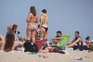 Two thick white girls in bikinis on the beach with big asses