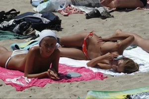 Girls on a nude beach in Sitges, Spain