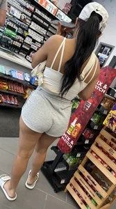 Sexy fit latina with cheeks coming out of booty shorts