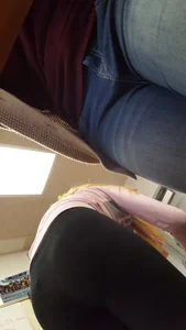 College blonde girl in a pink hoodie and leggings low angle creepshots in class