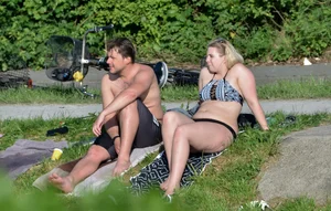 Thick blonde laying out in the sun in a bikini with her boyfriend