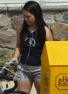 Thick brunette listening to music in shorts