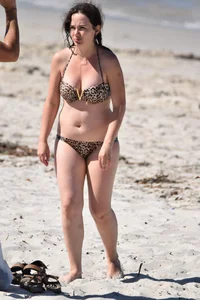 Brunette on the beach in a cheetah print bikini