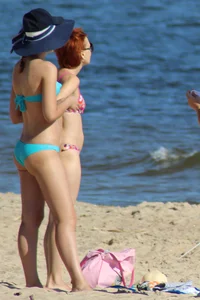Couple of hot babes hanging out at the beach in bikinis
