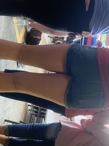 Bunch of girls in various outfits at a Cardinals baseball game