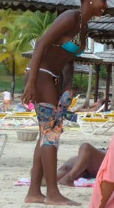 Sexy black babe in various bikinis on the beach while on vacation