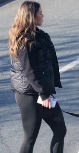 Pouting brunette teen in black leggings