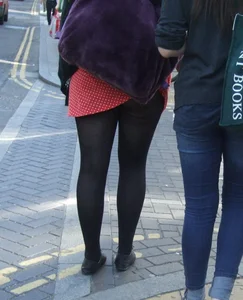Girl in a pink skirt and stockings accidentally showing some cheek