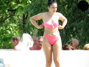 Smoking brunette in pink thong at the pool with camel toe