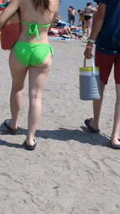 Beautiful Brown hair tight Girl in green bikini on the beach. oc