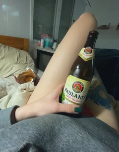 Tattooed Legs Bed Selfie with a Beer Bottle