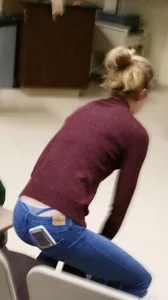 Blonde student in jeans showing her blue thong whale tail