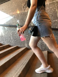 Hot chick wearing a fringed skirt walking up the stairs