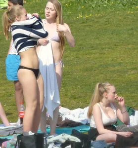 Teen taking off her dress in the park