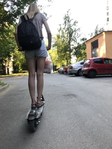 Skinny Candid Girl in Denim Shorts on a Scooter Suburban Street Creepshots