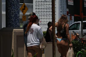 Two sexy friends in Florida walking in thong bikinis with nice asses