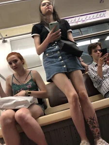 Two Girls With Hot Long Legs in Mini Shorts and Sneakers in the Subway Train Candid Photo Gallery